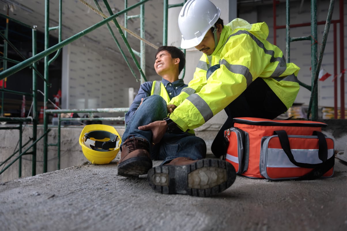 Accident at work of construction worker at site. Builder accident falls scaffolding on floor